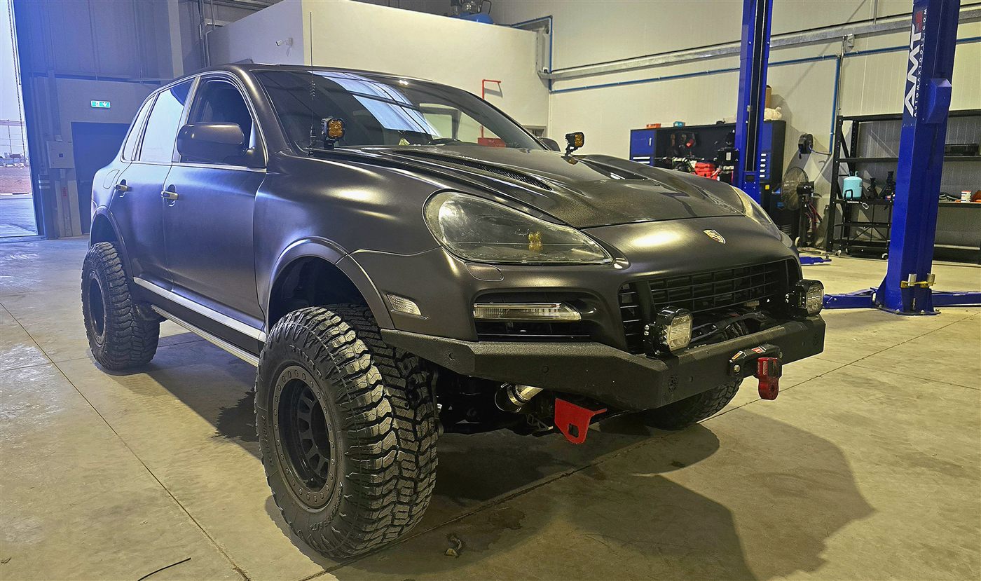 Lifted matte black Porsche Cayenne offroad build in the workshop