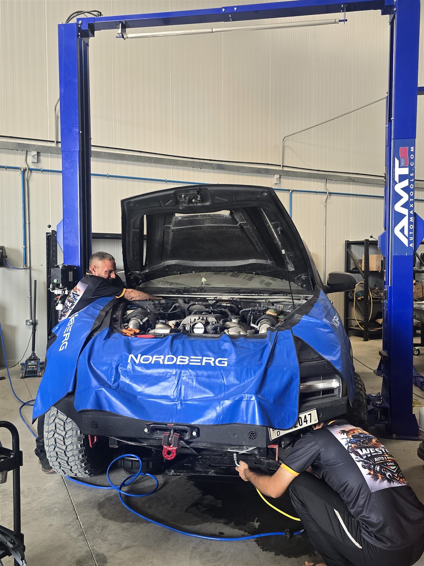 Technicians working on an engine bay rebuild