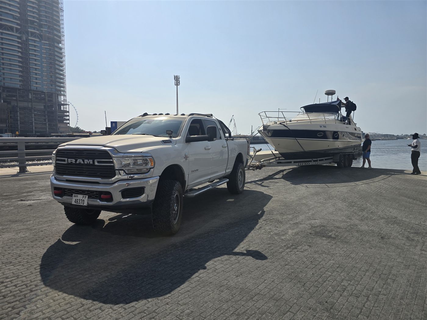 Ram truck towing a boat for Western Auto and Marine's trailer and transport service