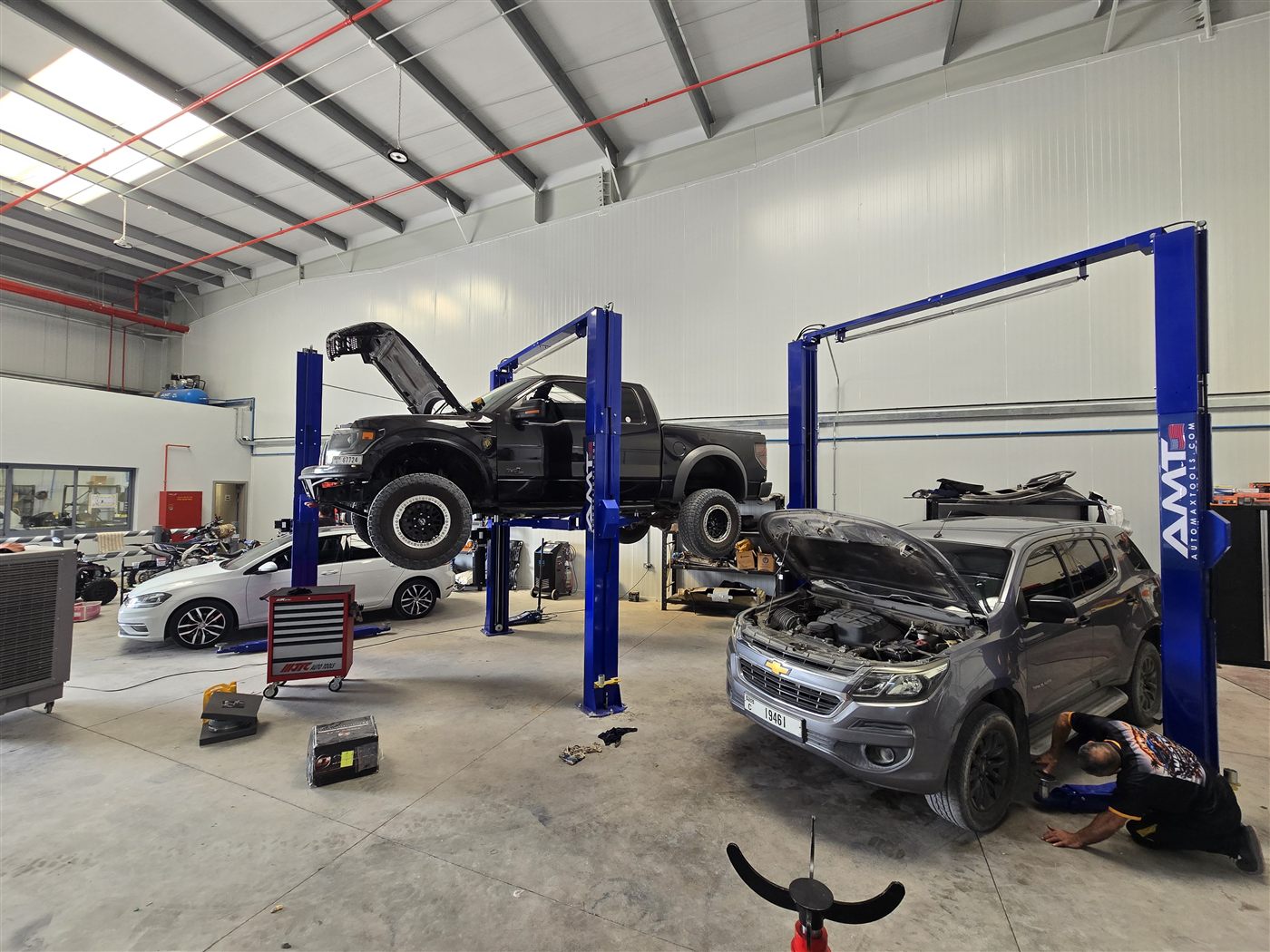Workshop floor with vehicles on the lift at Western Auto and Marine