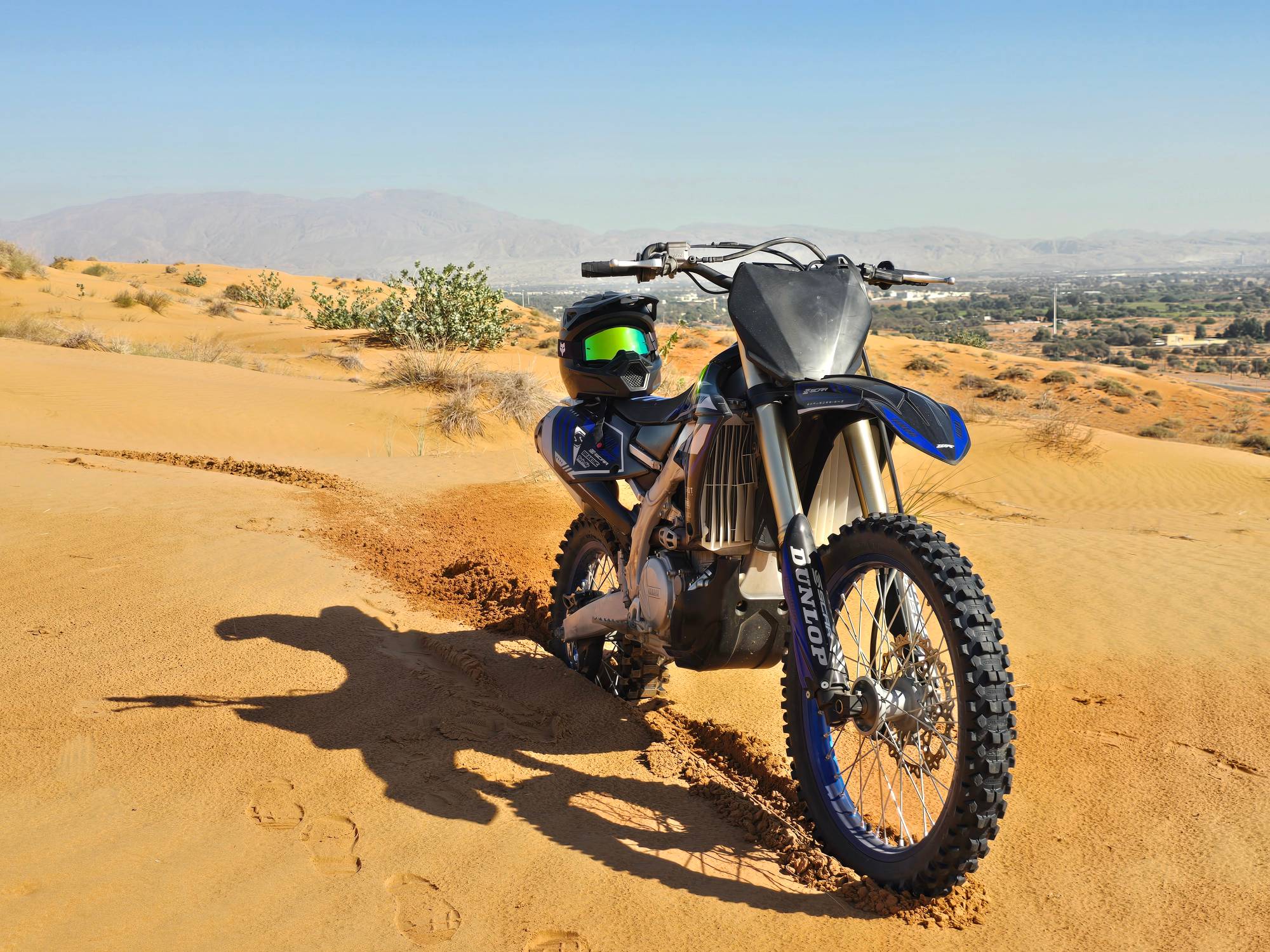Yamaha dirt bike on a sand dune overlooking Ras Al Khaimah
