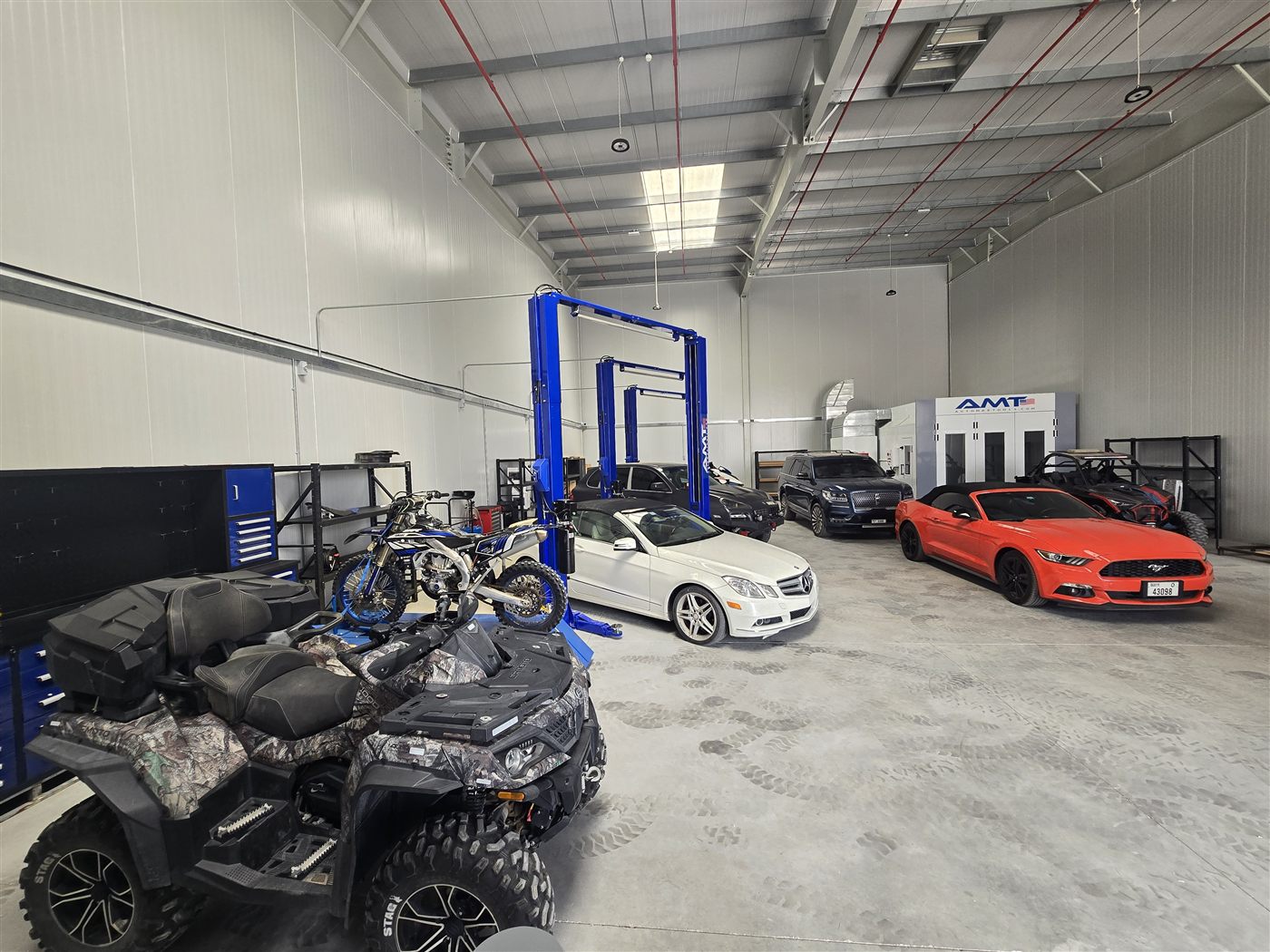 Inside the Western Auto and Marine workshop — vehicles, offroad equipment, and the paint booth all under one roof